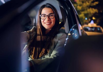 business woman driving a car in a city during a ni 2025 04 01 06 17 45 utc