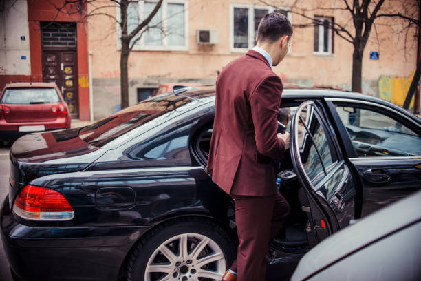 businessman standing next to his car and about to get in